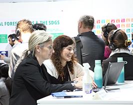 UN DESA's Ariel Alexovich and Nadine Salame at the SDG Pavilion at COP29.