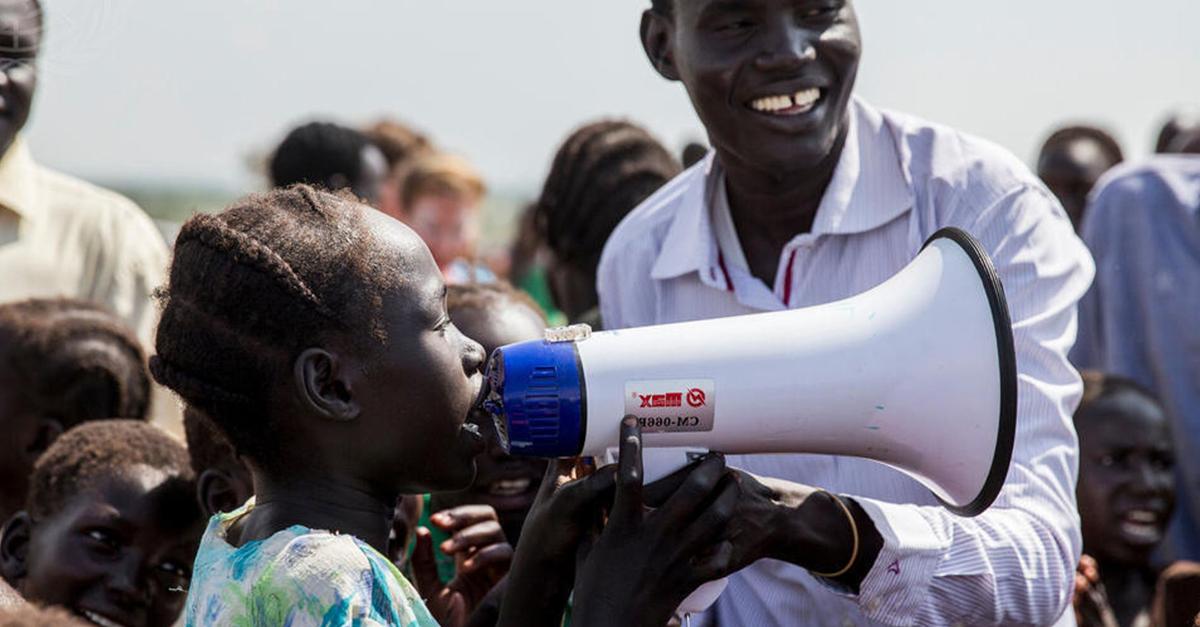 Young girl speaks up using a megaphone.